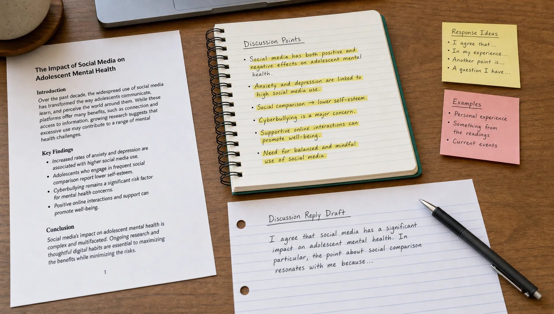 A desk with a notebook open to highlighted discussion points, a printed course article beside it, sticky notes with short response ideas, and a pen beside a half-written discussion reply draft.